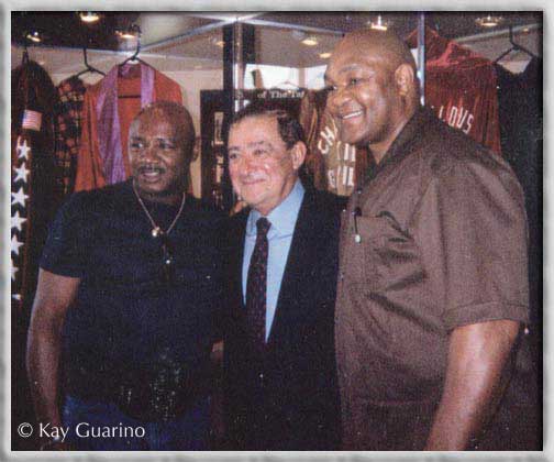 The Marvelous One with promoter Bob Arum,
and world heavyweight champion George Foreman.